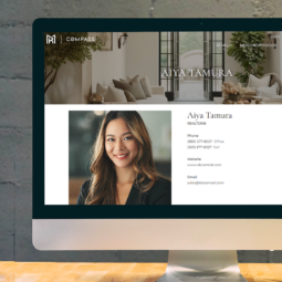 pc on table with realtor bio page displayed